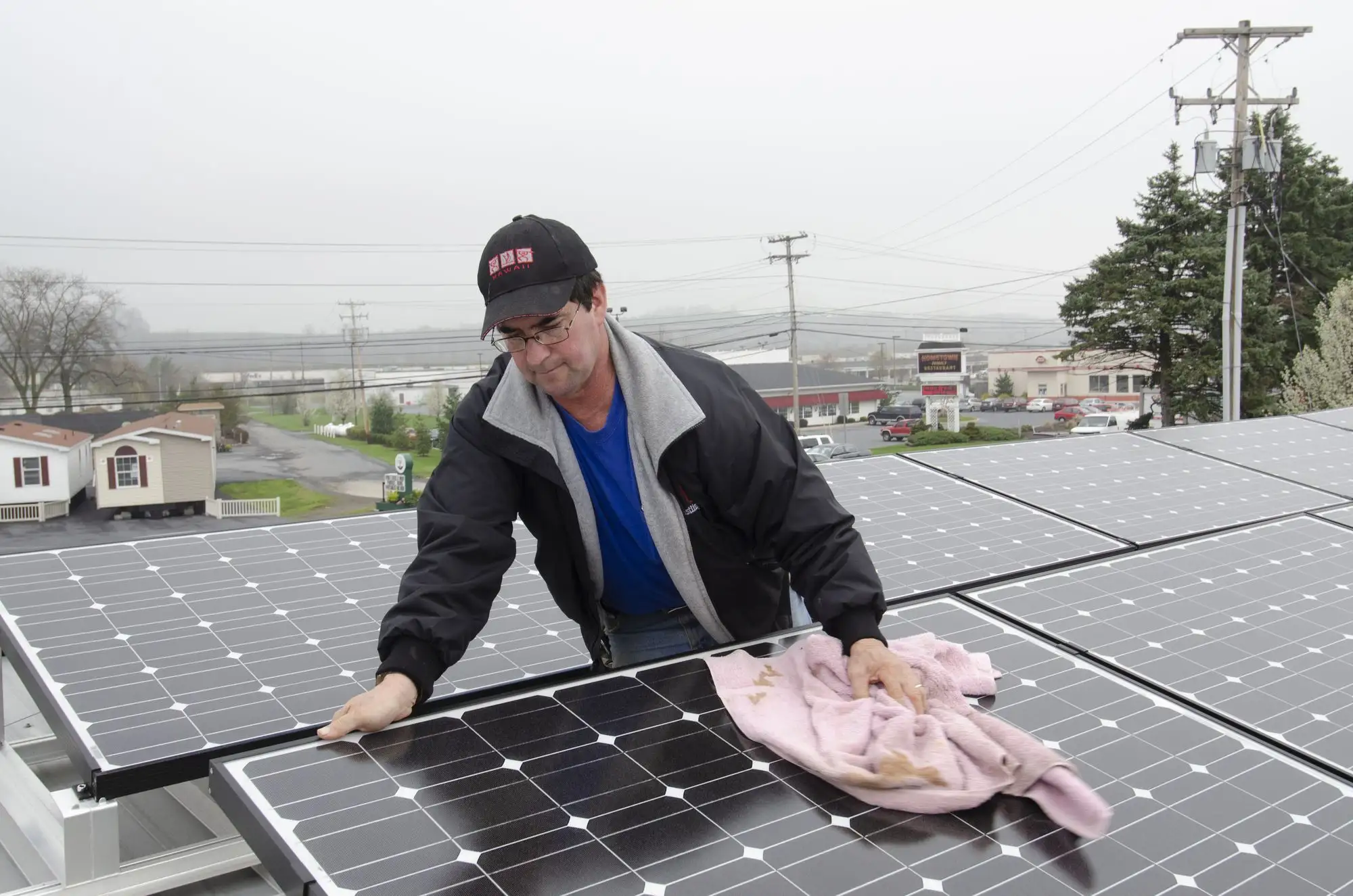 Solar panels being cleaned on a roof