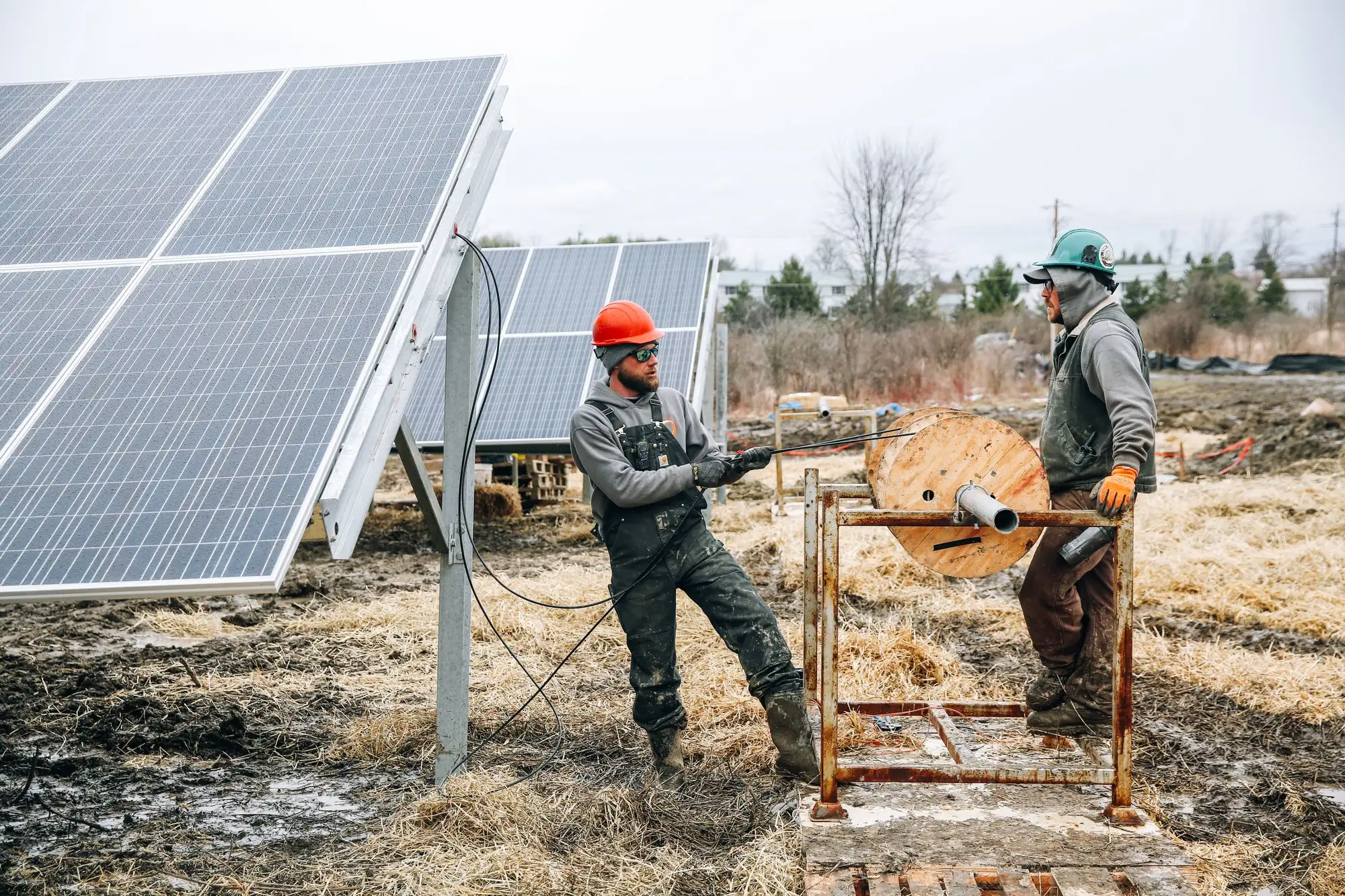 Crew installing a ground-mounted solar array