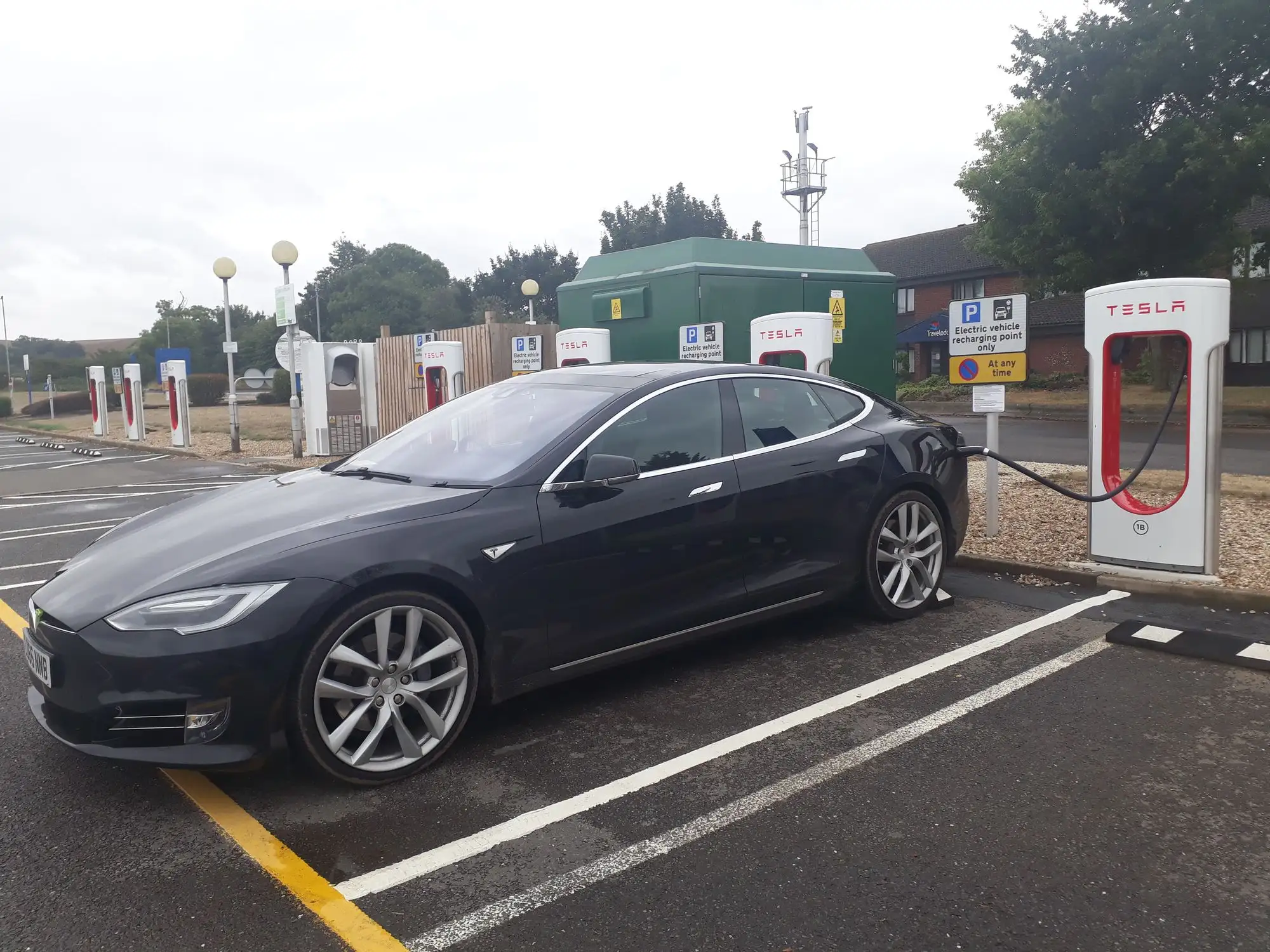 Electric vehicle plugged into a charging station